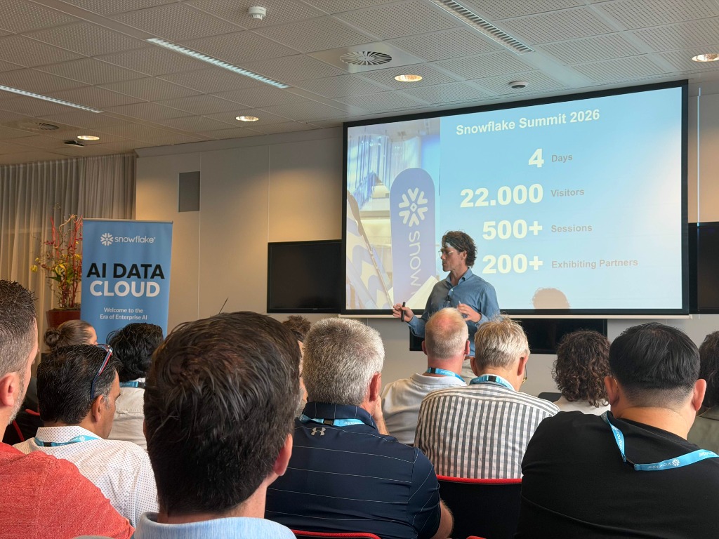 Snowflake Summit Encore Amsterdam 2026 — presenter on stage with Snowflake Summit 2026 statistics